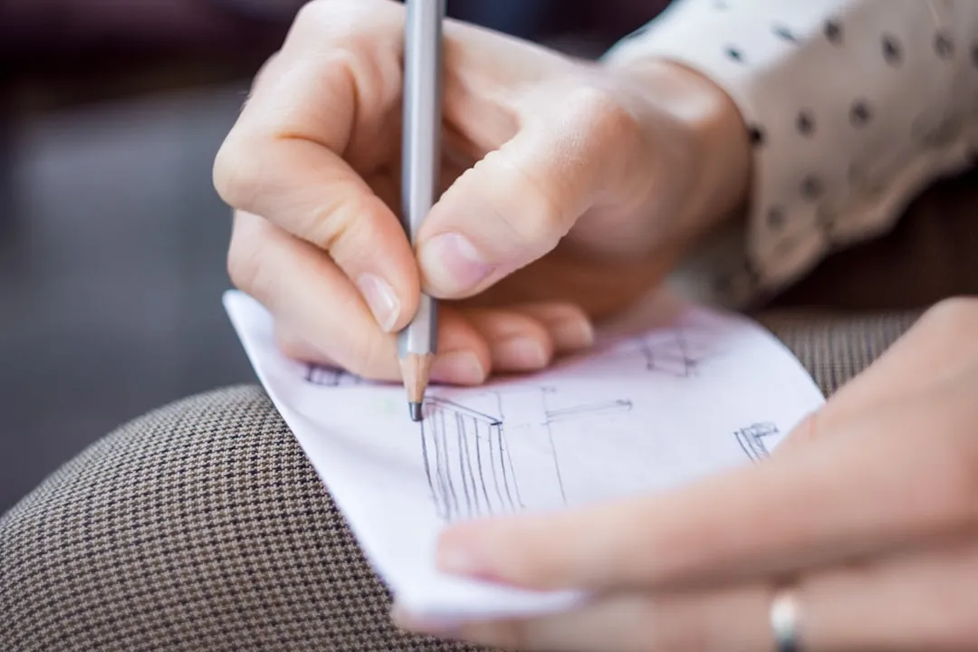 Person writing on white paper