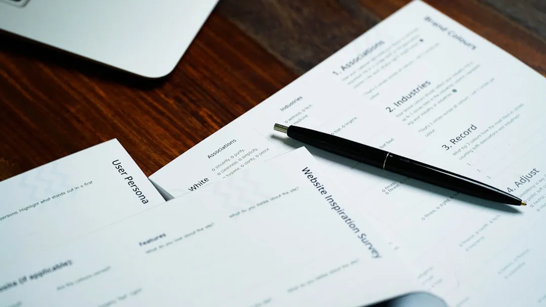 A pen on top of a stack of papers