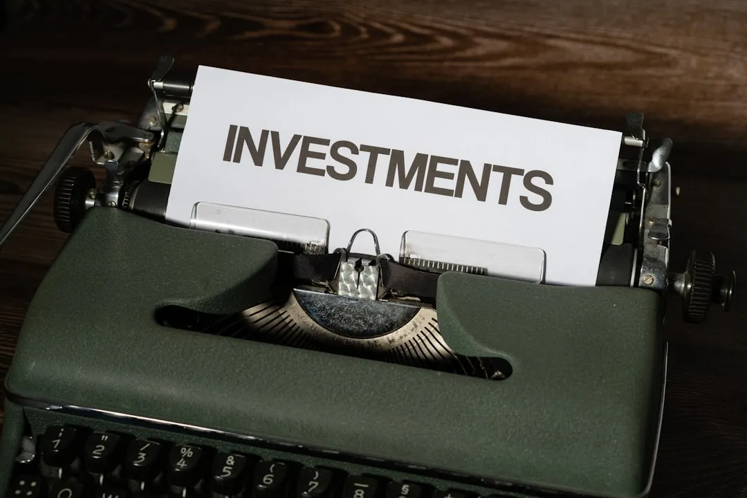 A close-up of a typewriter with a paper that reads investments