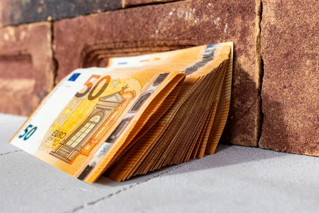 A stack of money on top of a sidewalk