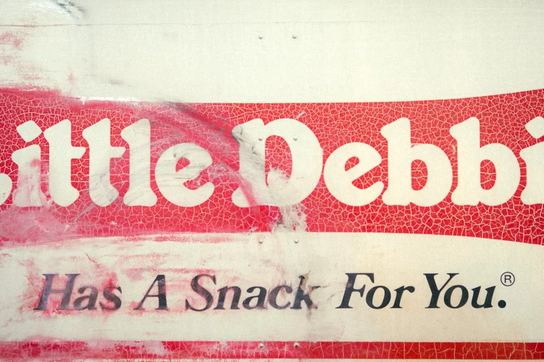 A red and white sign that says little pebble has a snack for you