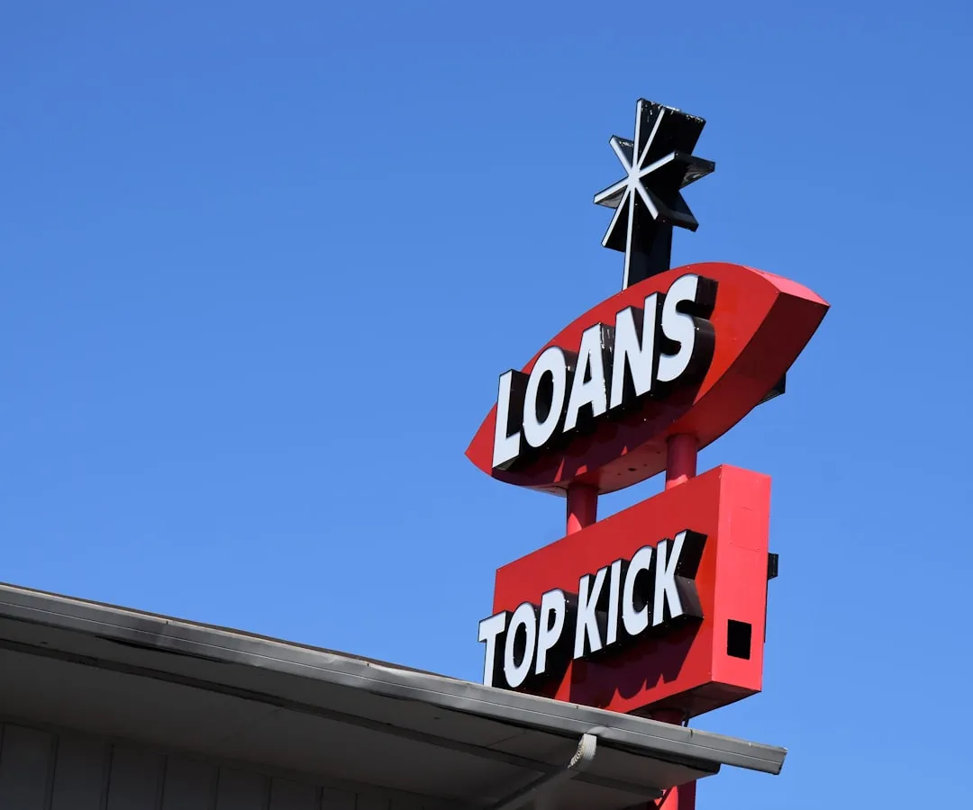 A sign for a top shop against a blue sky