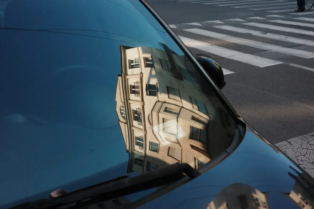 Reflection of a building on a car's windshield with a crosswalk.