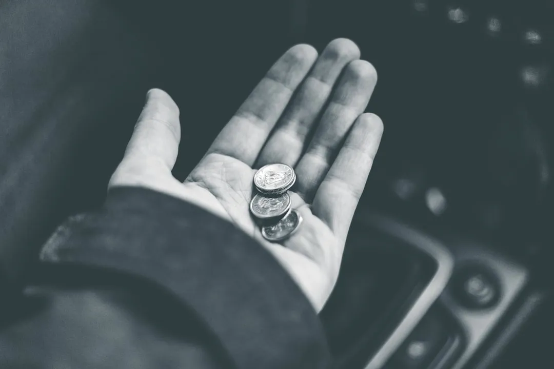 Grayscale photo of a person wearing a ring